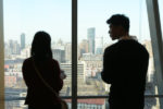 Young man and women looking out at Beijing from Penn Wharton China Center